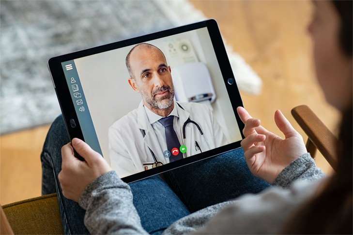 patient talking to doctor on tablet during telehealth session.