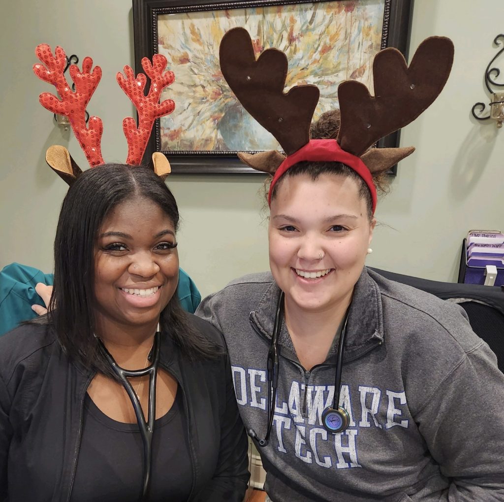 picture of team members at the office wearing reindeer headbands.